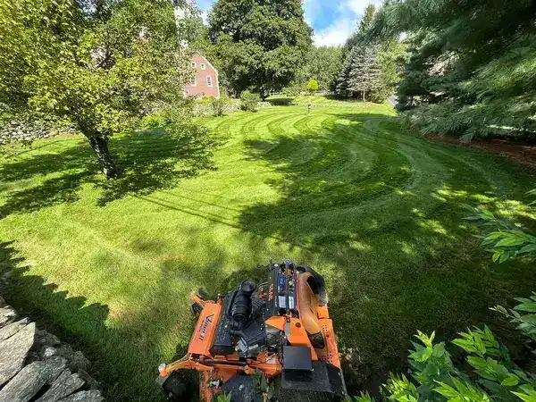 Commercial lawn mowing equipment in action